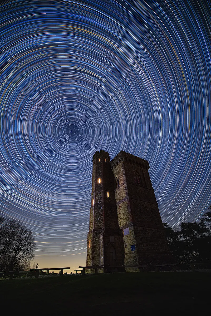 Leith Hill tower beneath circular star trails, with the night sky rotating above the highest point in the south east.