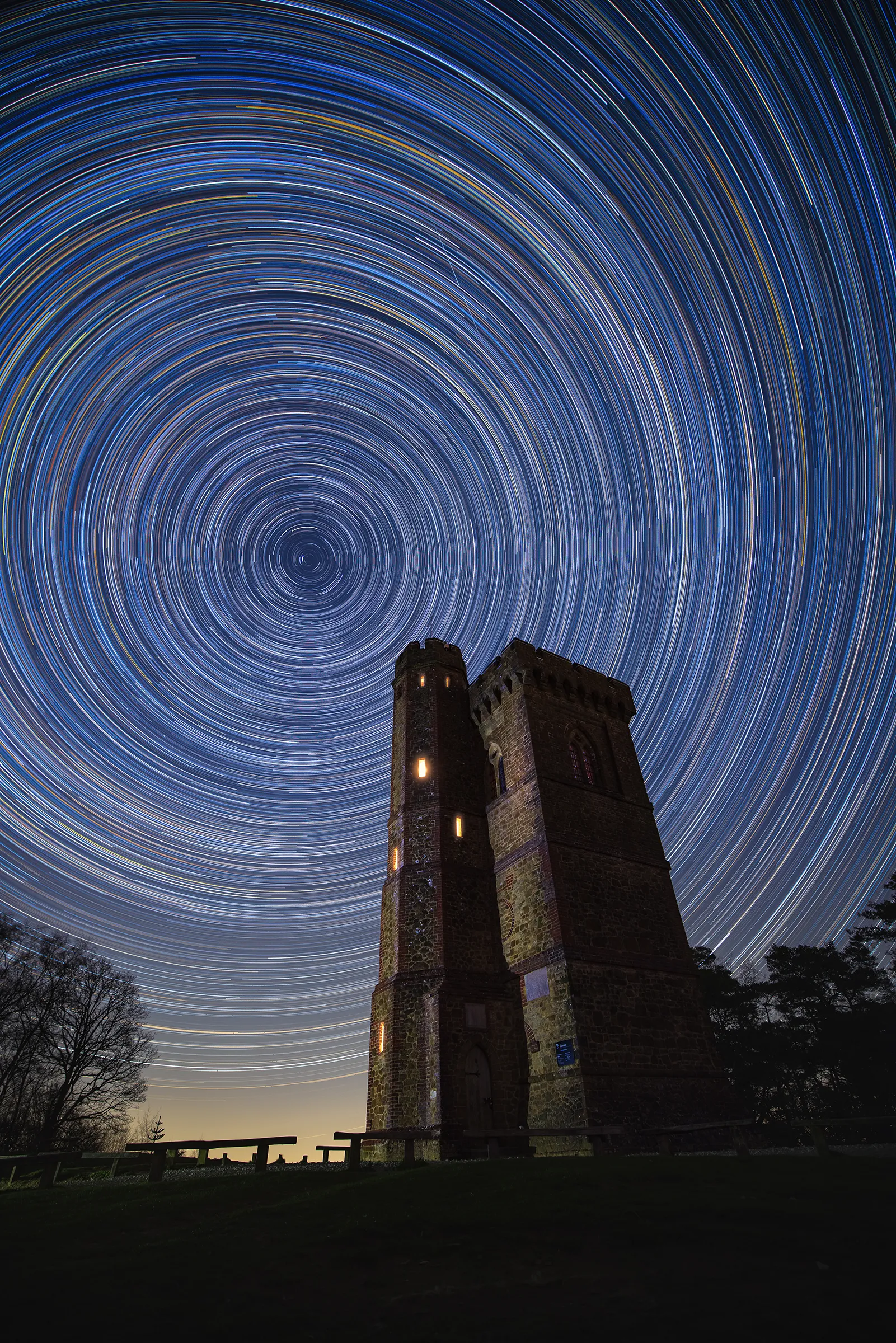Leith Hill tower beneath circular star trails, with the night sky rotating above the highest point in the south east.